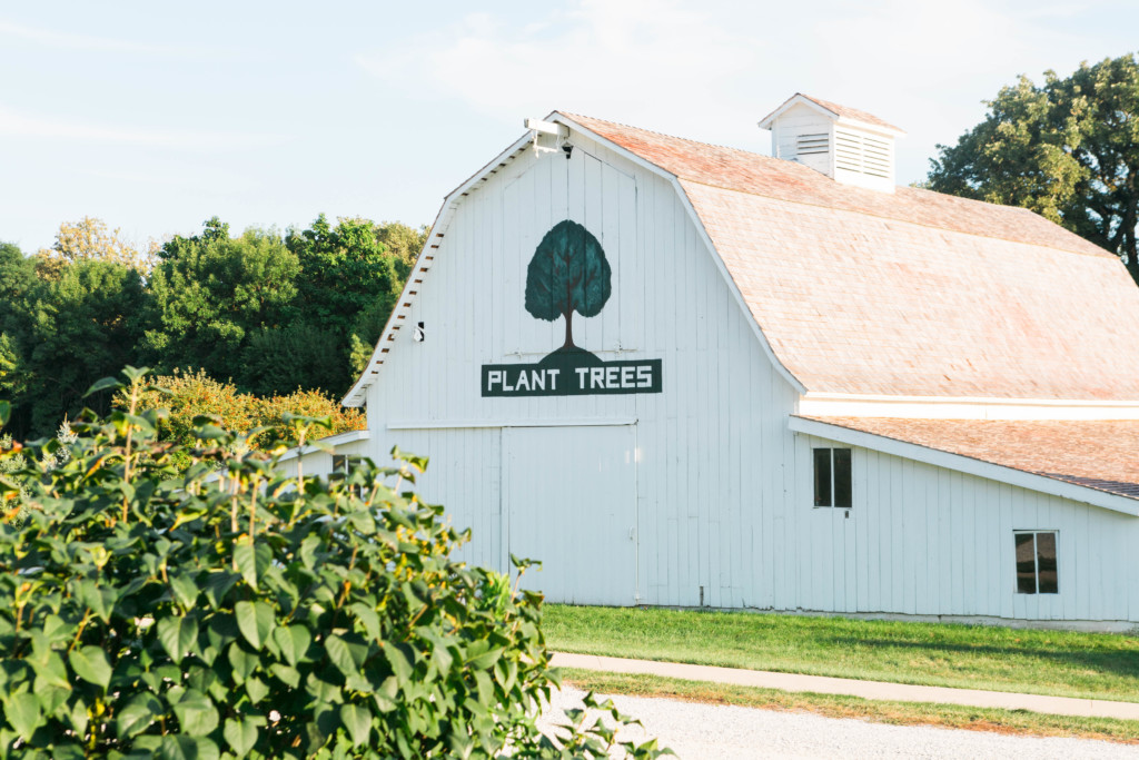 White barn in Nebraska City that says Plant Trees